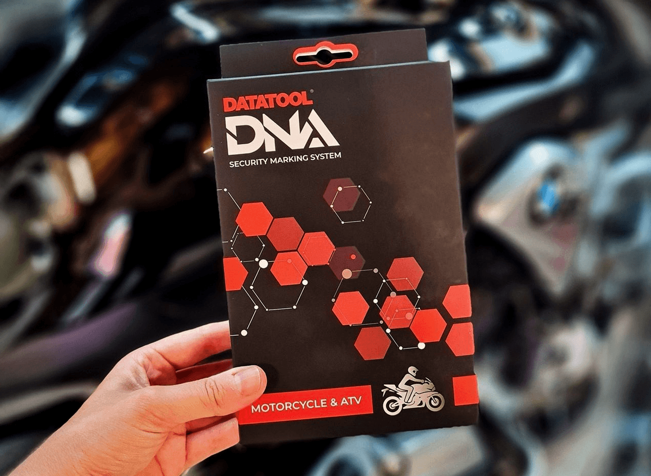 The Datatool DNA box being held in front of a BMW Motorcycle